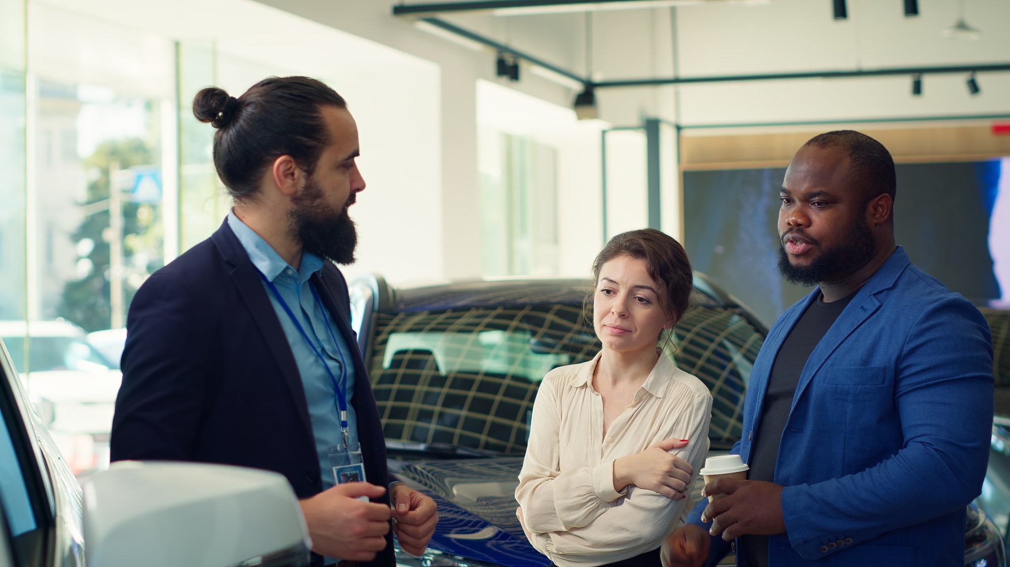 Showroom agent assisting customers in selecting the right vehicle for them